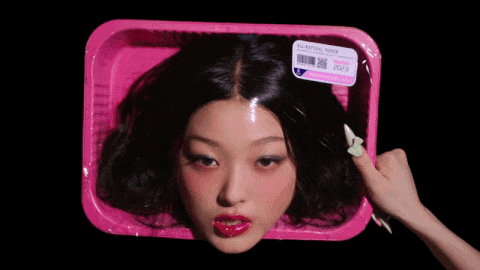 a woman 's head is in a pink plastic container with a label that says all natural foods