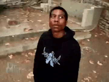 a man wearing a black hoodie with a blue butterfly on it