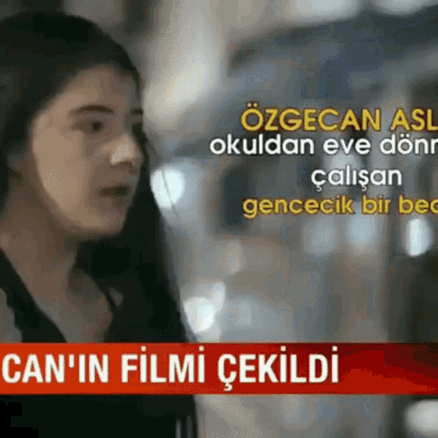 a woman in a black shirt is talking to someone in a red banner that says can 'in film