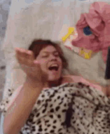 a woman laying on a bed with her mouth open