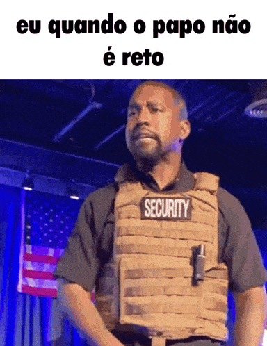 a man wearing a security vest stands on a stage