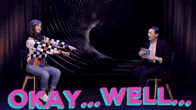 two women are sitting in front of a screen that says " okay well "