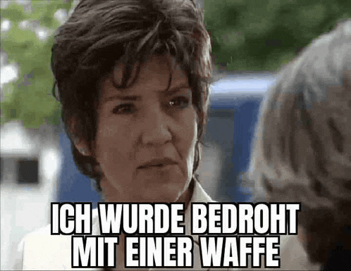 a woman with short hair is talking to another woman in german .