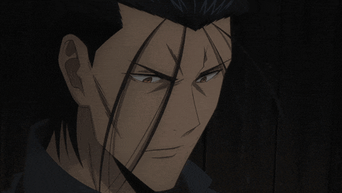 a close up of a man with long black hair