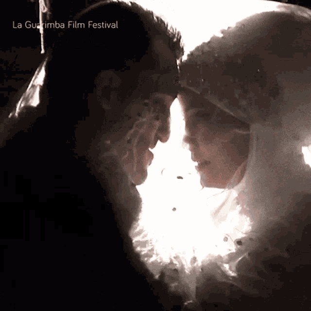 a man and a woman are looking into each other 's eyes with the words la guajira film festival written below them