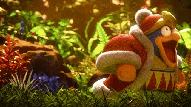 a stuffed animal with a crown on its head is standing in the grass