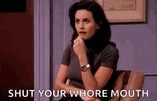a woman is sitting in a chair with her hand on her chin and the words `` shut your whore mouth '' written next to her .