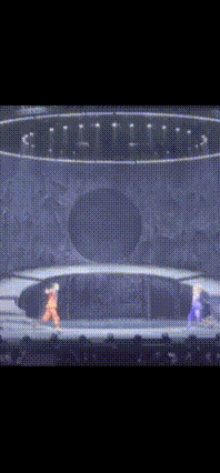 a video game screen shows two characters fighting in a circle