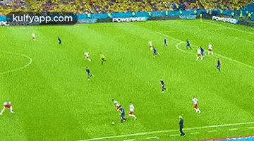a group of soccer players are playing soccer on a field .