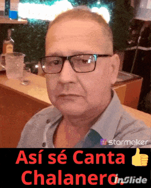 a man wearing glasses stands in front of a sign that says así se canta chalanero in slide
