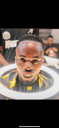 a man is getting his hair cut by a barber wearing a shirt that says nice