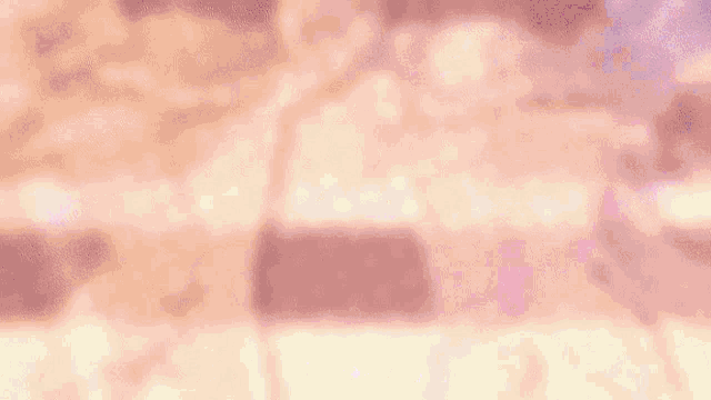 a blurred image of a group of pink glasses filled with liquid .