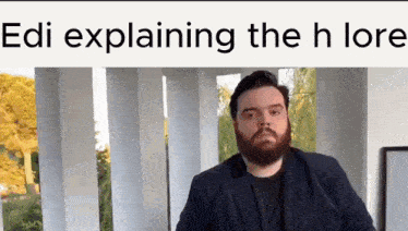 a man with a beard is standing in front of a building with the words edi explaining the h lore written above him .
