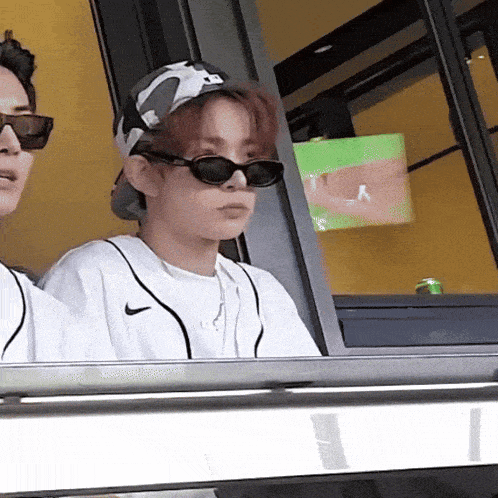 a person wearing sunglasses and a nike shirt