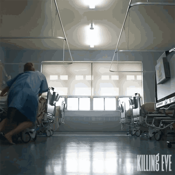 a poster for killing eve shows a man in a hospital gown