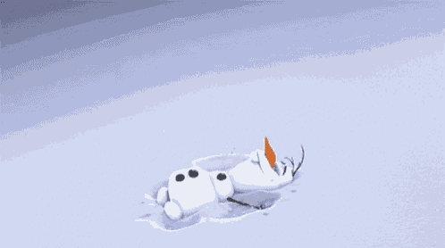 a snowman is laying in the snow with an orange nose and antlers .
