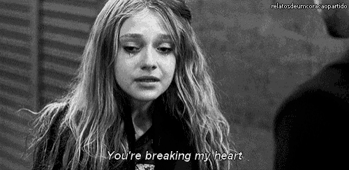a woman is crying in a black and white photo with the words `` you 're breaking my heart '' .