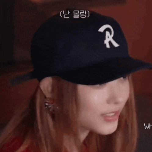 a woman wearing a baseball cap with a letter r on it .