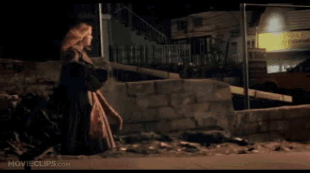 a movie clip from movieclips.com shows a woman walking down a street at night