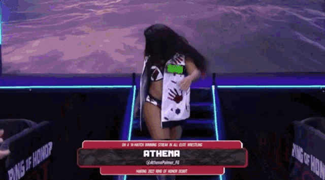 a woman in a bikini is walking down a set of stairs with the name athena on the screen behind her