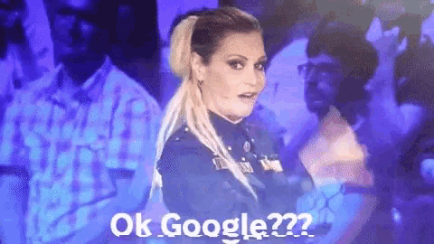 a woman with a ponytail is standing in front of a crowd and says ok google