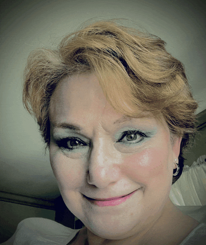 a close up of a woman 's face with blue eye shadow