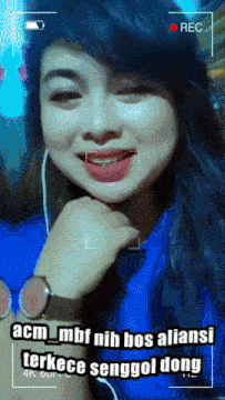a woman wearing headphones and a watch is being recorded by a camera