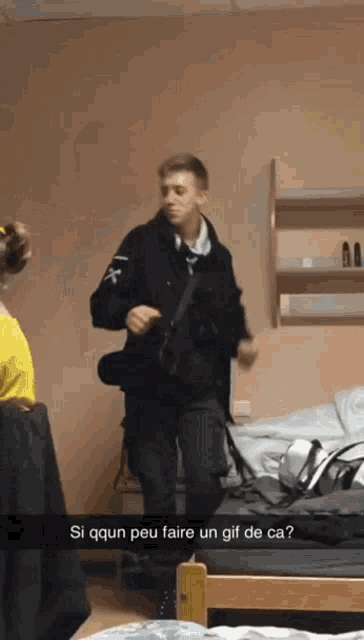 a man is dancing in a room with a caption that says si qqun peu faire un gif de ca?