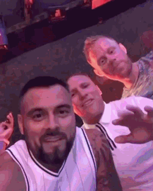 a group of men are posing for a picture together in a club .
