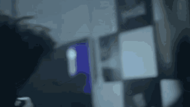 a blurred image of a person looking at a screen