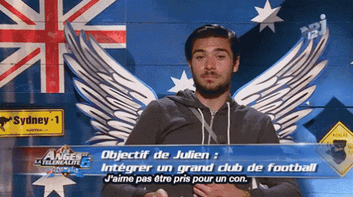 a man with wings is standing in front of a british flag
