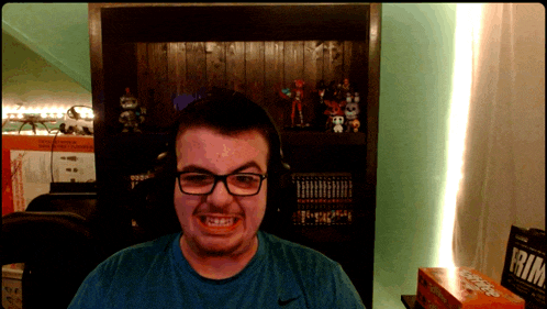 a man wearing glasses and headphones stands in front of a shelf with a box that says rim