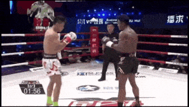 two boxers are fighting in a boxing ring with the time of 01:56
