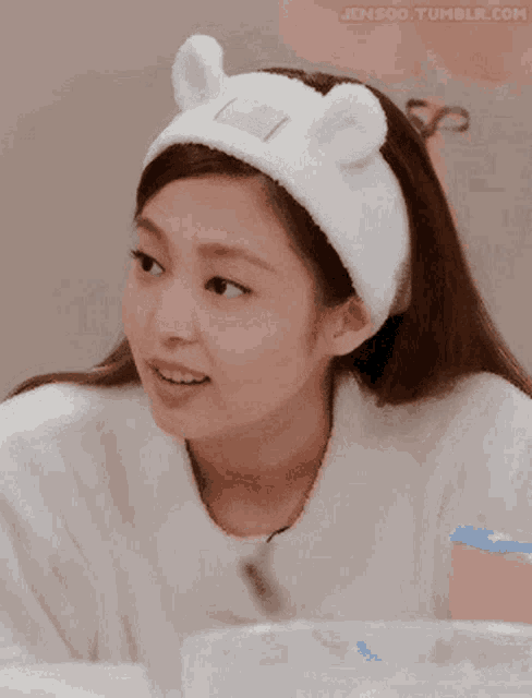a woman wearing a headband with ears on it