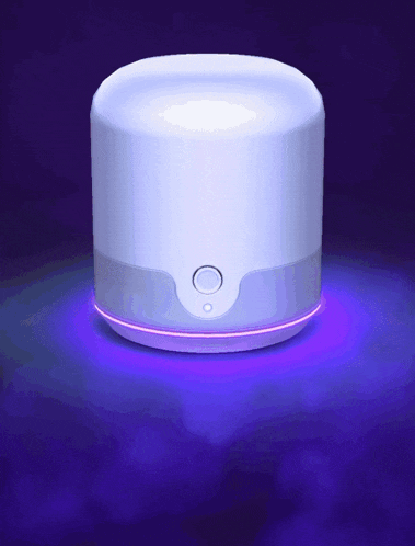 a white device with a purple light coming out of the top