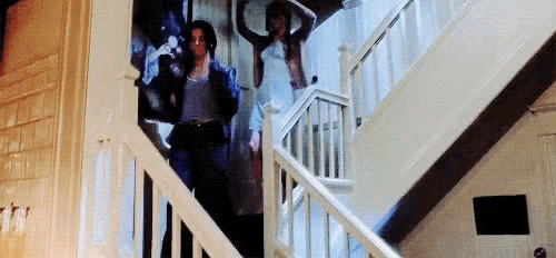 a group of people are walking up a set of stairs .