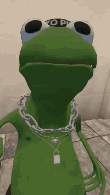 a green frog wearing a chain around his neck and a hat that says ' no pi ' on it