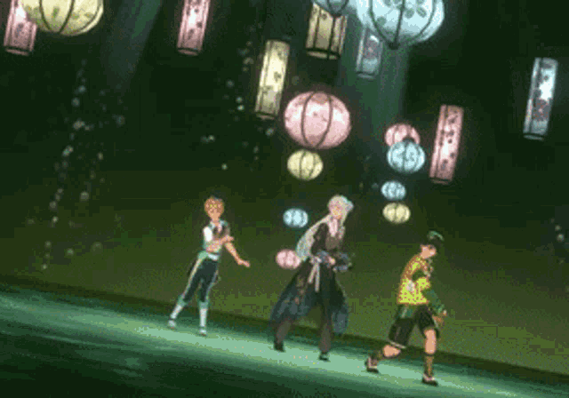 a group of people are dancing under lanterns in a dark room