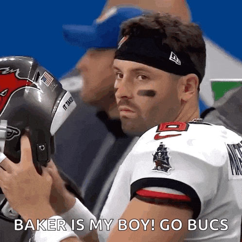 a football player says baker is my boy go bucs while putting on his helmet