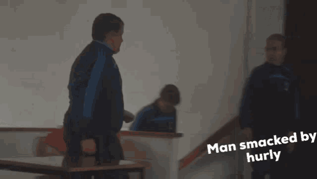 two men standing next to each other with the words man smacked by hurly written on the bottom