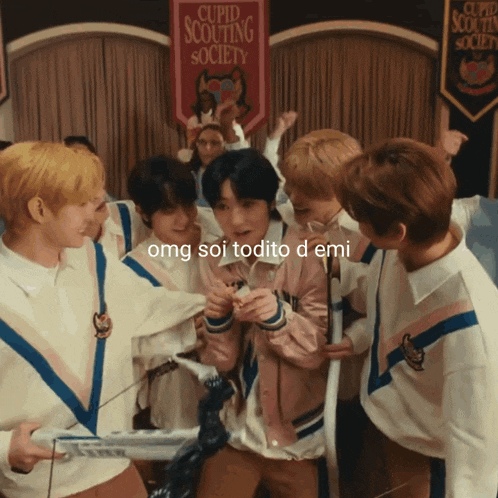 a cupid scouting society banner hangs above a group of young men