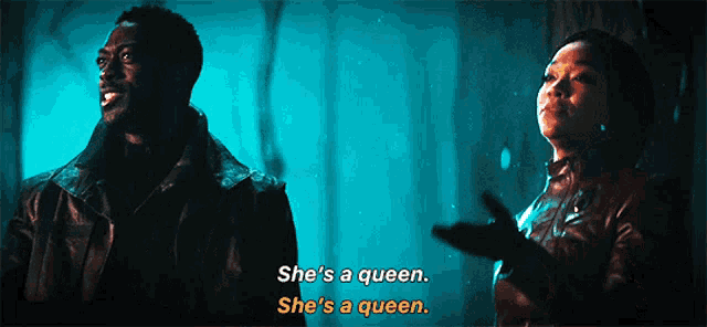 a man and a woman are standing next to each other and the man says she 's a queen