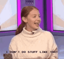 a woman in a white sweater is laughing and says i don 't do stuff like that