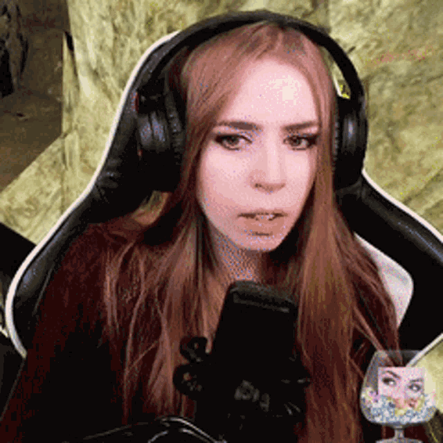 a woman is wearing headphones and holding a cell phone