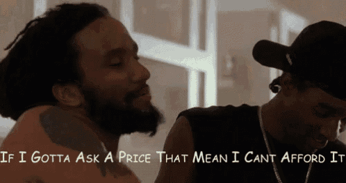 a man with a beard is talking to another man who is wearing a hat