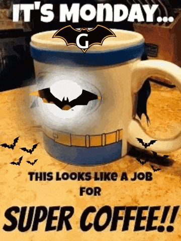a coffee mug with a batman logo on it is on a table .
