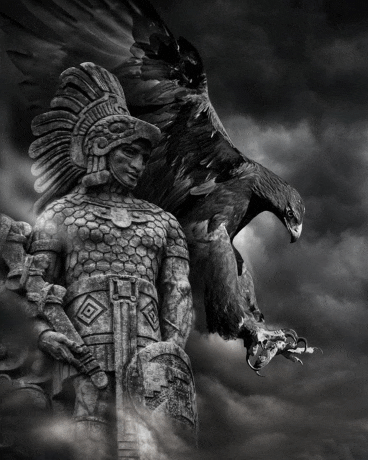 a black and white photo of a statue of a man with an eagle standing behind him