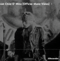 a black and white photo of a man standing in front of a microphone in a band .