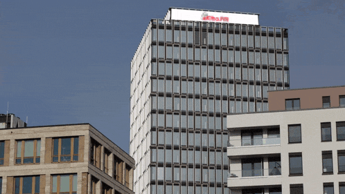 a tall building with a sign on the top that says ' allianz '