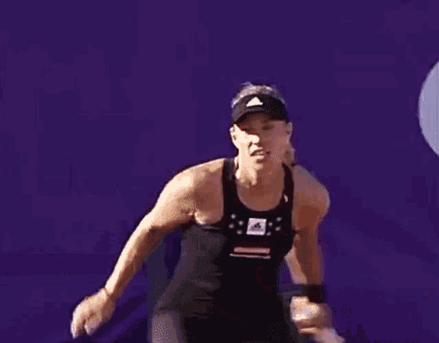 a man and a woman are standing next to each other on a purple background .